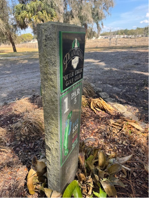 An existing stone hole-marker monument at The Plantation at Leesburg’s Otter Creek Golf Club, Hole 1, Par 5, photographed on site before the sponsor plaque insert was fabricated.